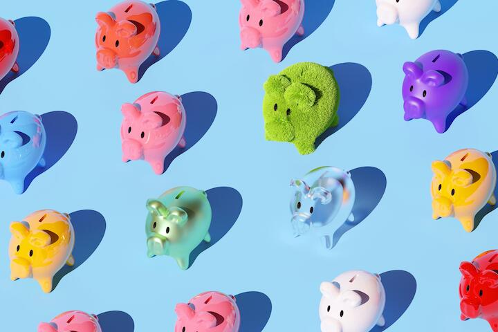 Bunte Sparschweine, teilweise in Plüschoptik vor blauem Hintergrund.