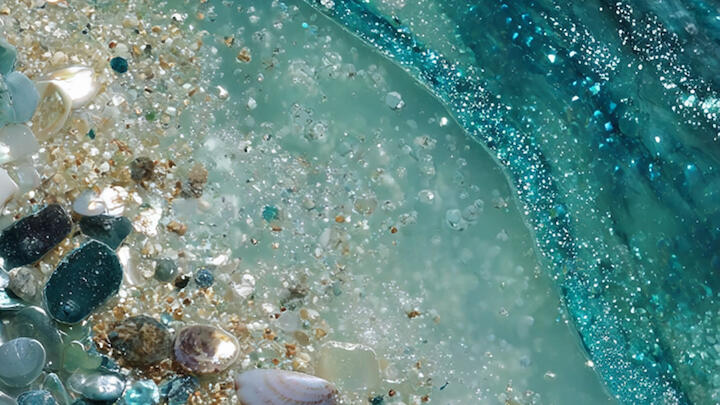 Strand mit Glitzer und Steinen in den Schattierungen von Mermaidcore