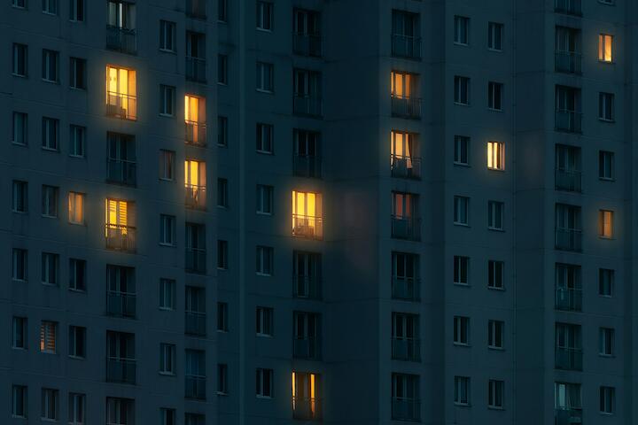 Hochhaus bei Nacht mit beleuchteten Fenstern