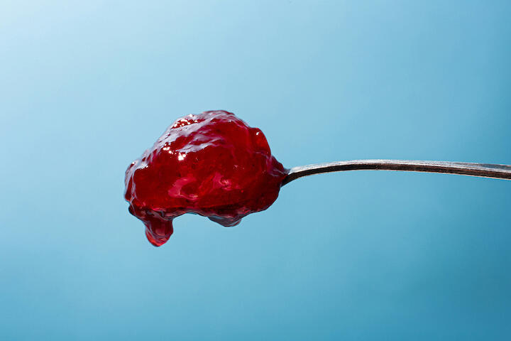 Nahaufnahme eines Löffels mit viel Erdbeermarmelade.