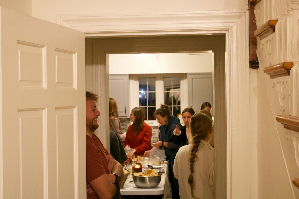 menschen stehen um ein potluck-dinner herum